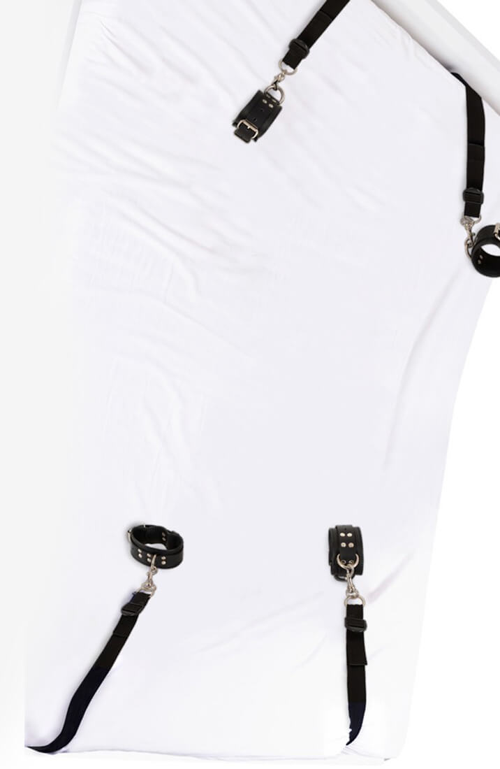 Bed restraint set fastened under mattress with cuffs in each corner