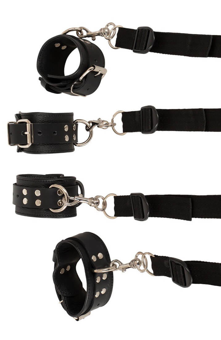 Four black leather restraints arranged flat showing detail and buckles