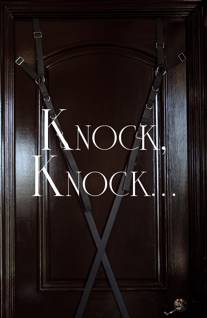 Black adjustable door restraint straps with gold-tone rings and hardware