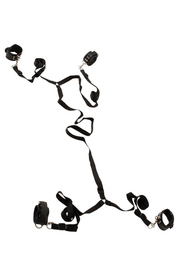 Full view of black bed restraint system laid out on white background