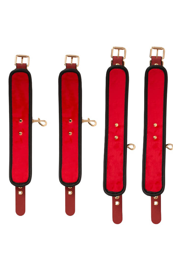 Adjustable black restraint straps with burgundy padded wrist and ankle cuffs